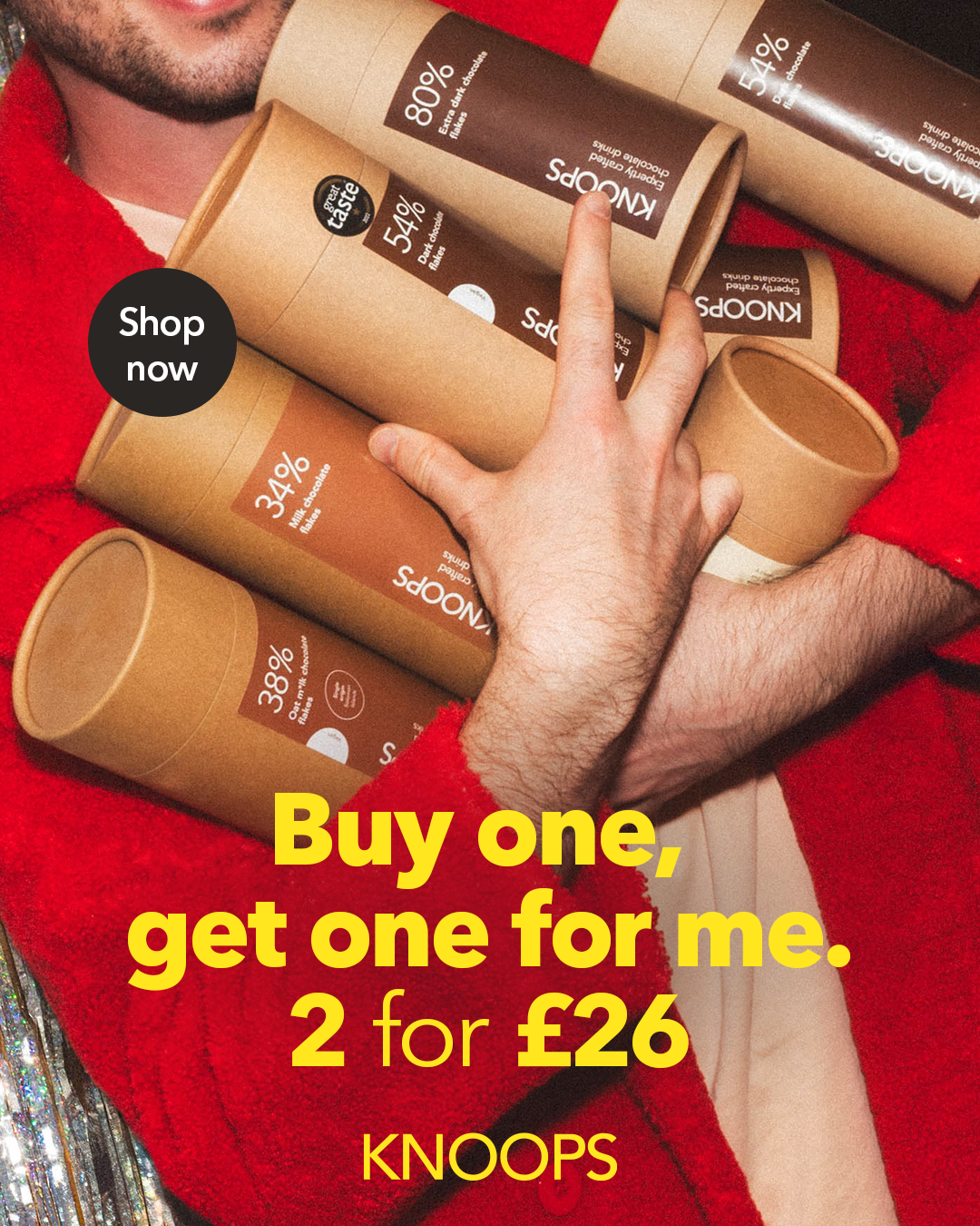 A vibrant promotional image featuring a person, hands clutching multiple cylindrical packaging of chocolate mixes in earthy tones, showcasing percentages for cocoa content. They wear a striking red fluffy coat, contrasting against a glittery background that sparkles under atmospheric lighting, enhancing the dynamic mood.