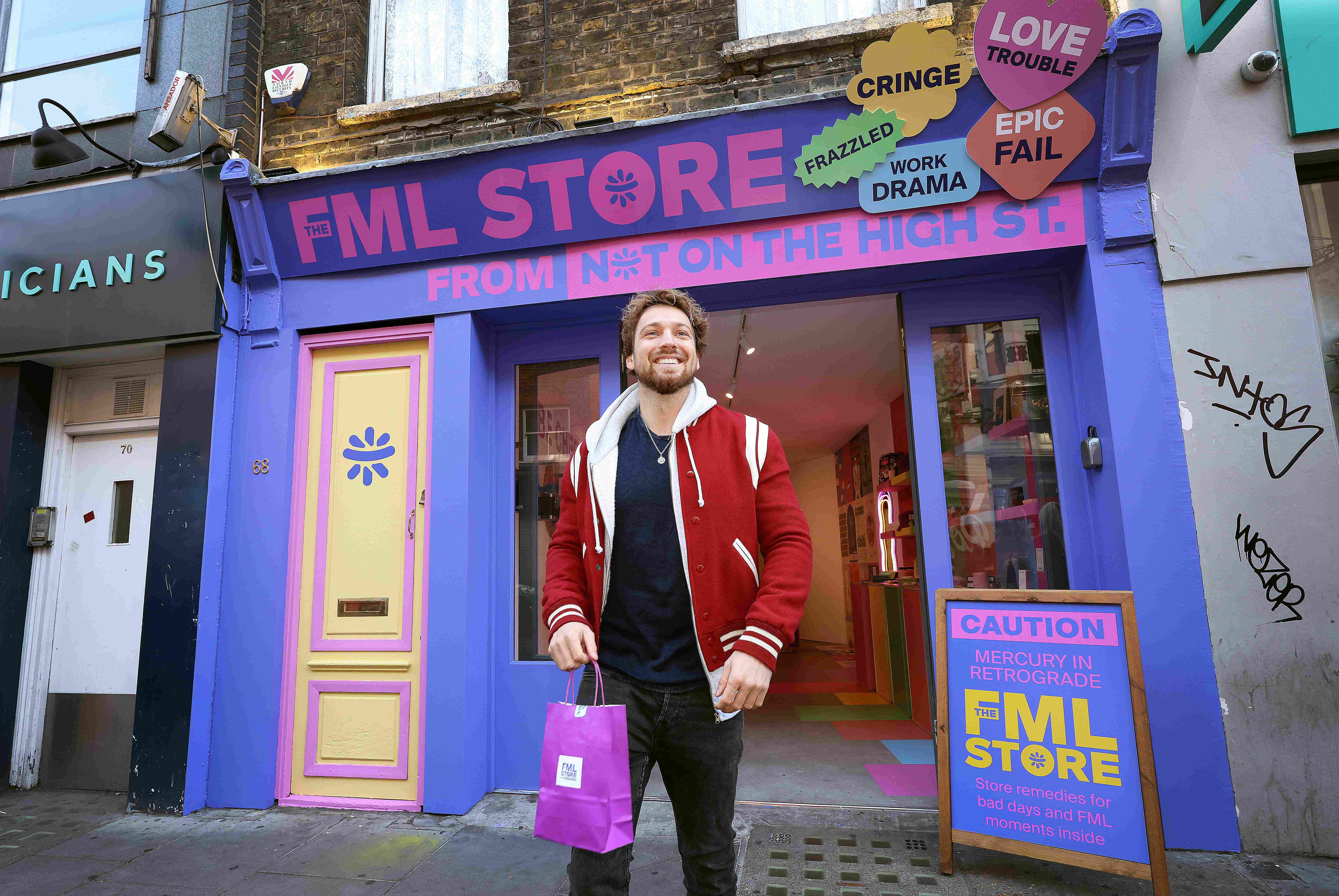A man stands with his shopping outside the NOTH FML store