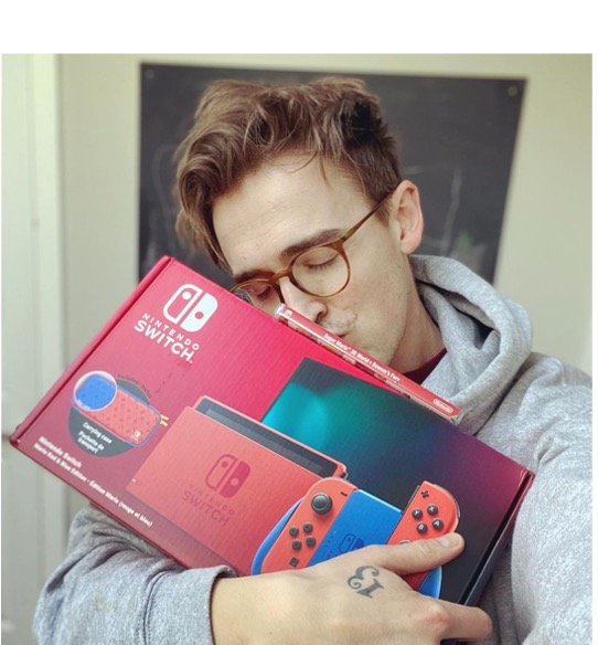 A man kissing his Nintendo Switch