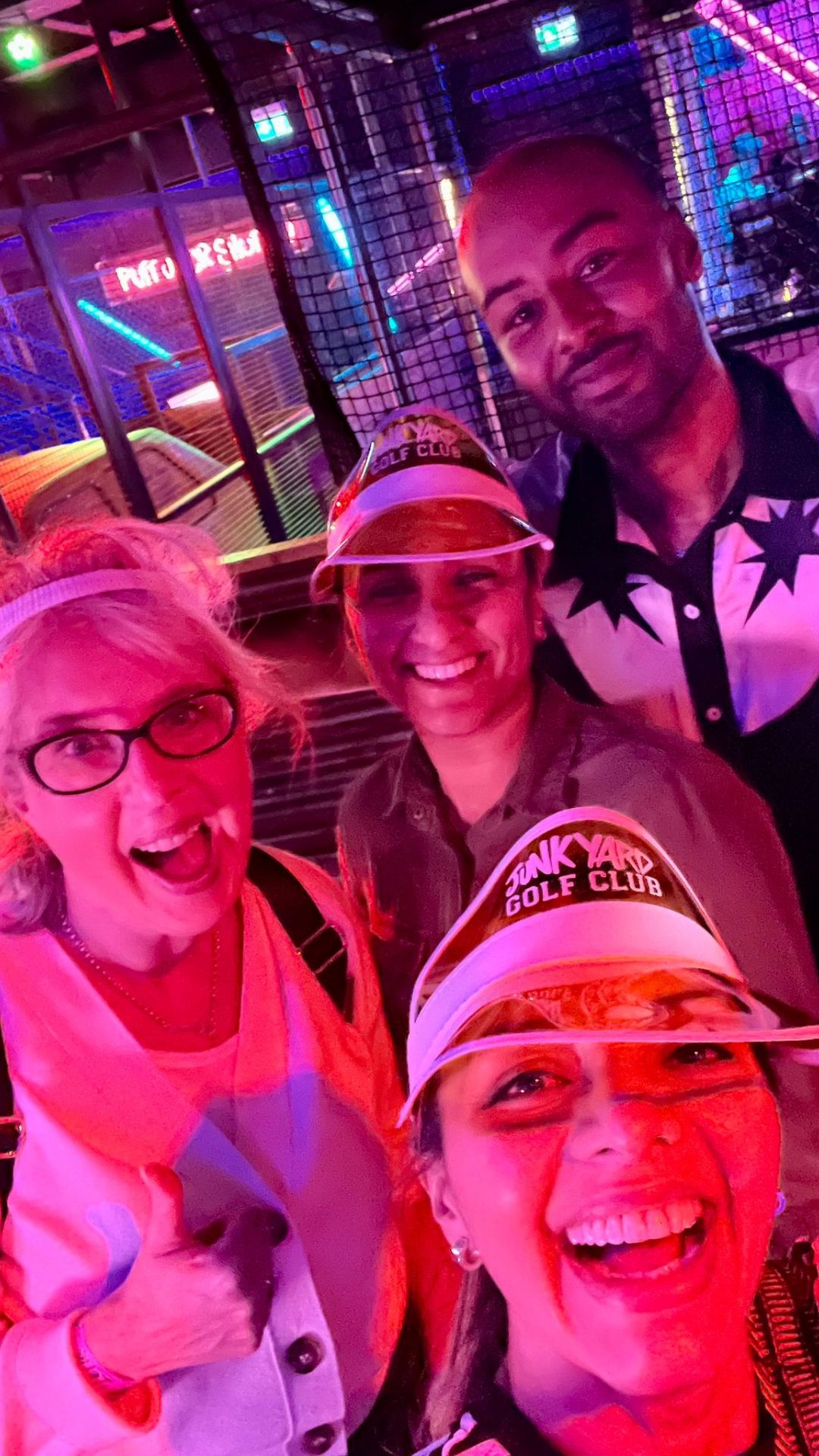 Selfie of the team wearing golf visors