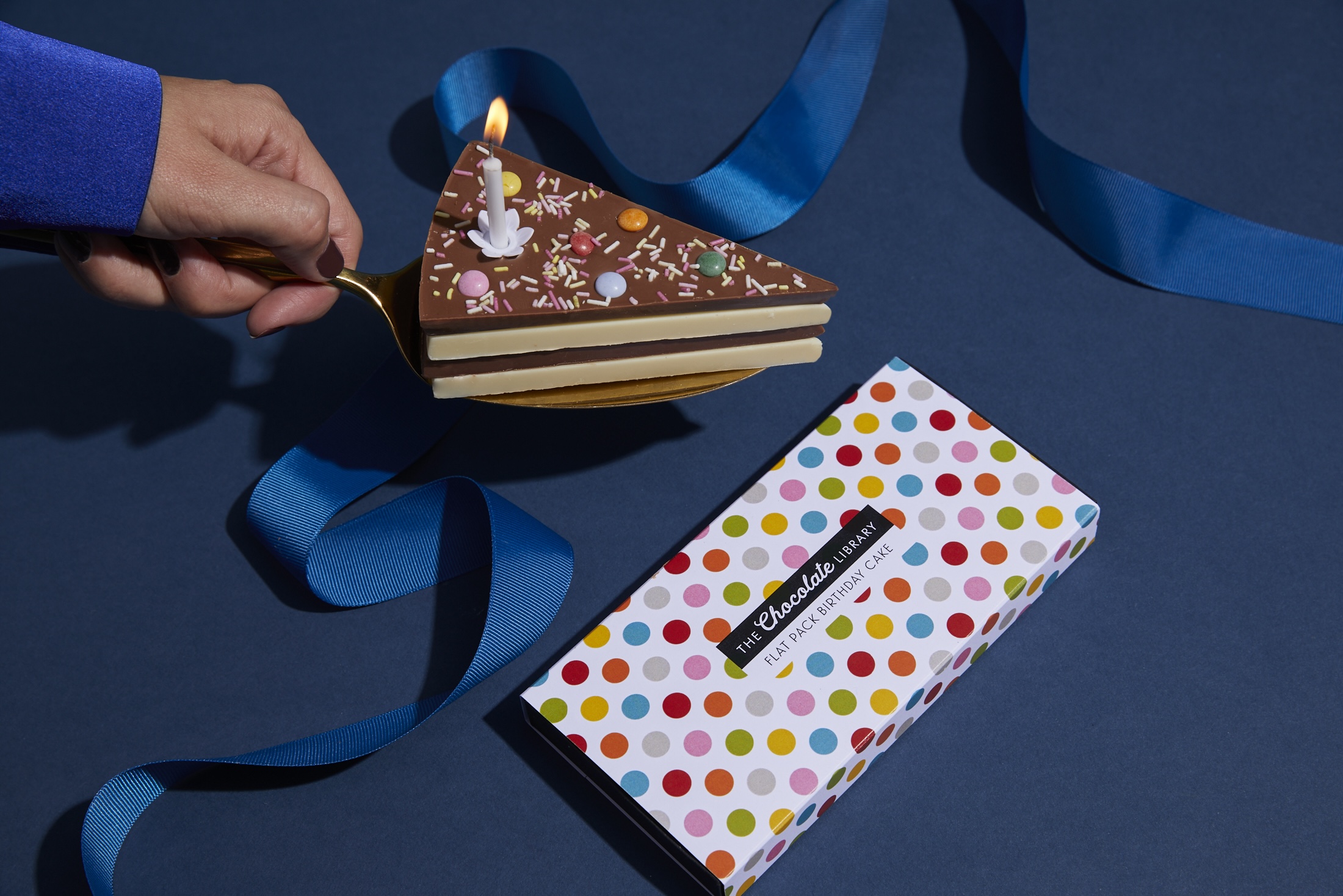 A slice of chocolate cake next to a giftbox
