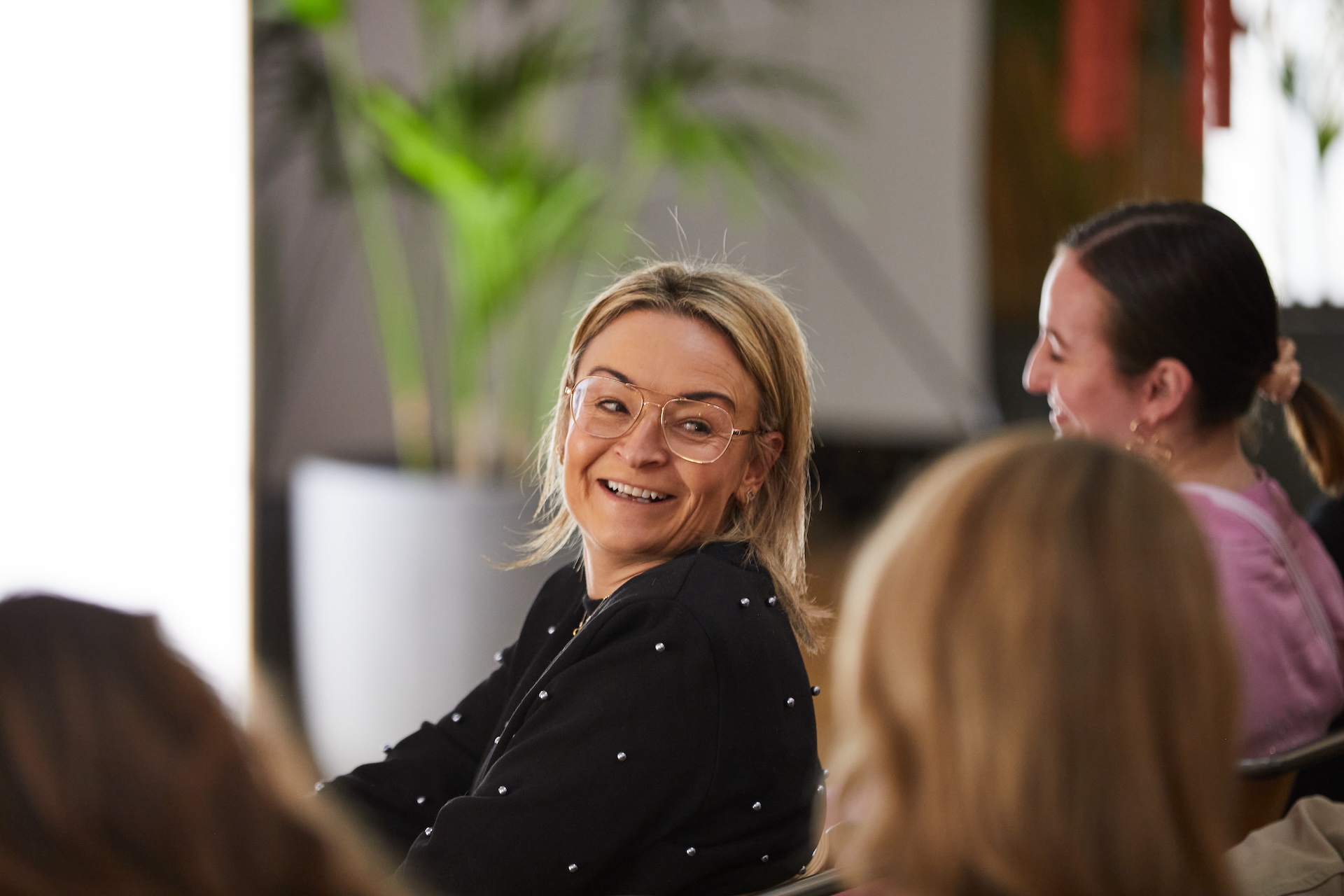 A woman turning round in her chair