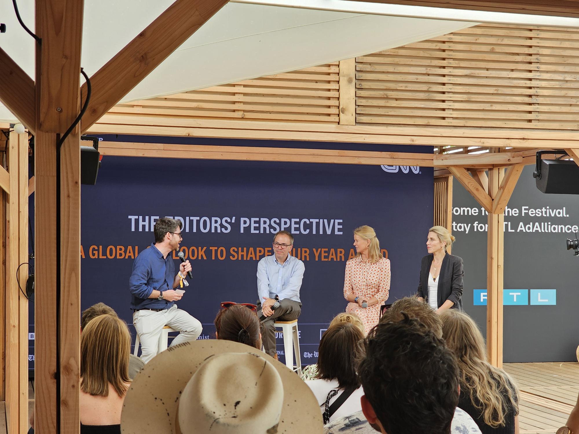 4 people are in discussion at a panel outside