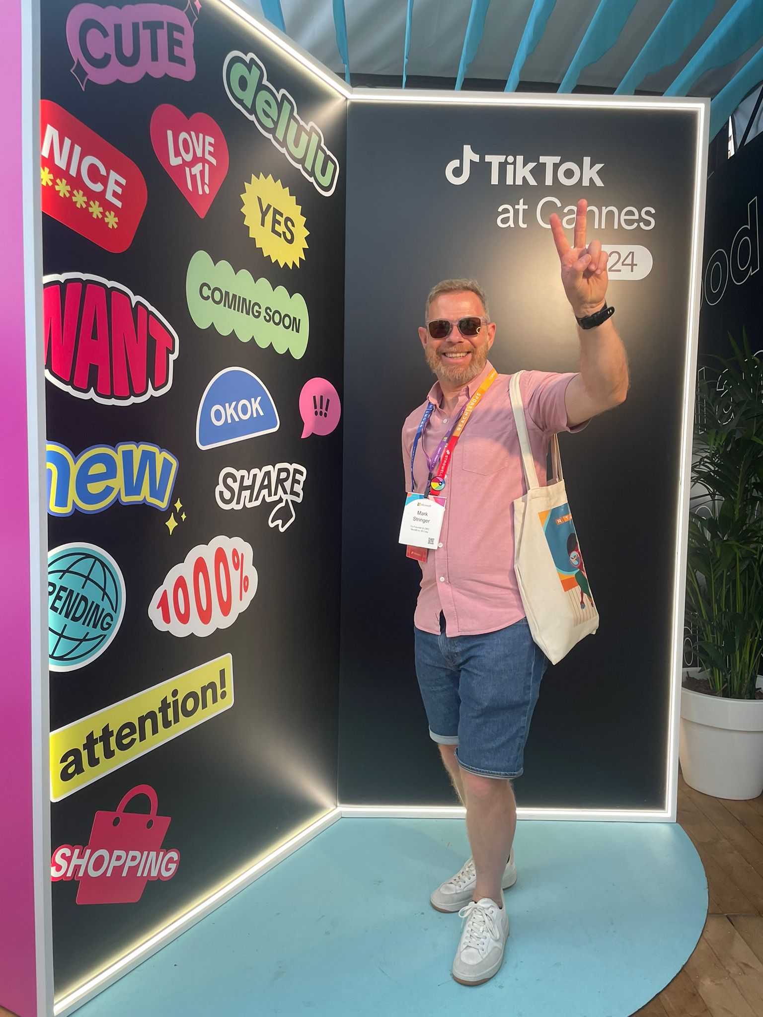 A man poses in a TikTok booth